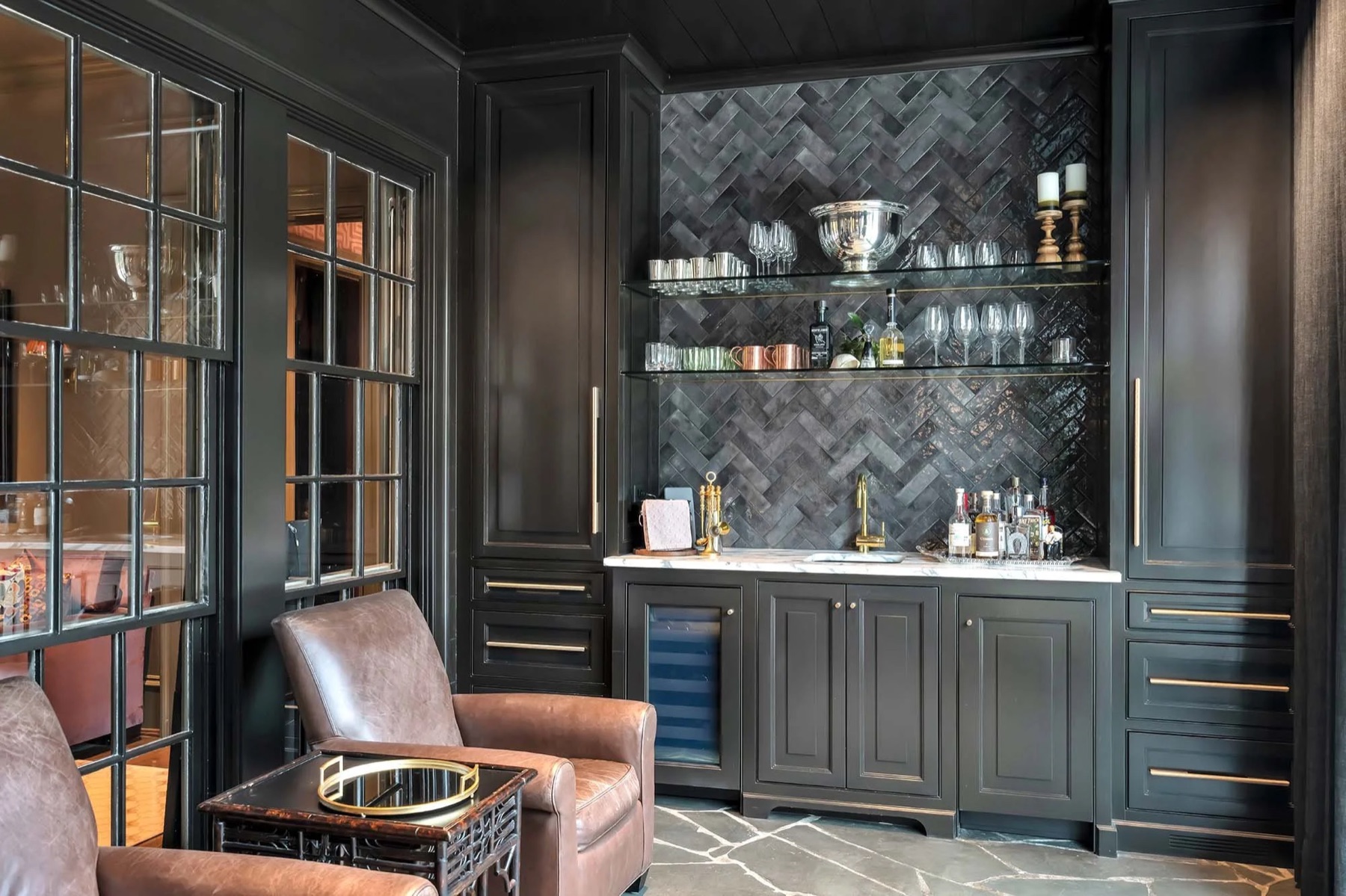 Custom dark stained bar cabinetry with glass shelving and brass hardware built by MM Custom Woodworks