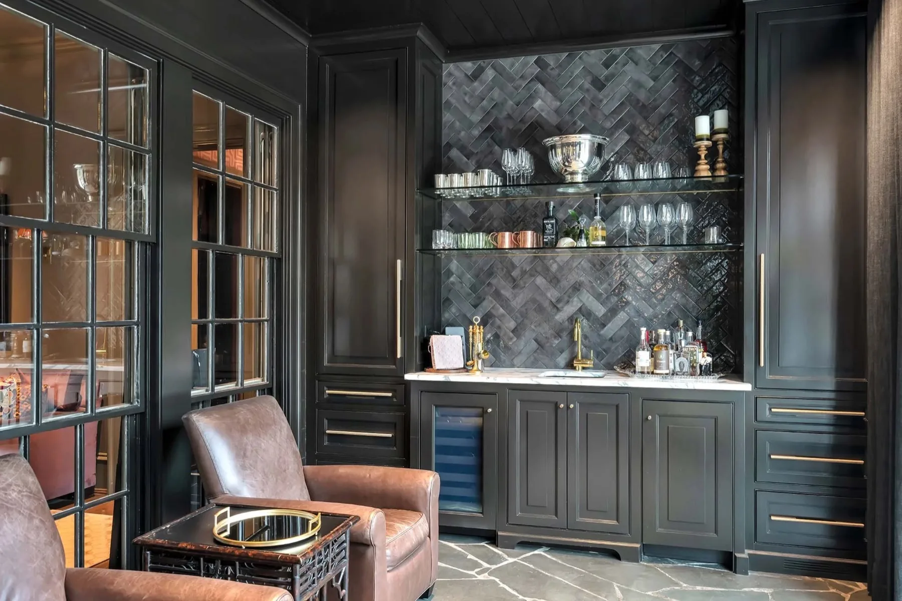 Custom dark stained bar cabinetry with glass shelving and brass hardware built by MM Custom Woodworks